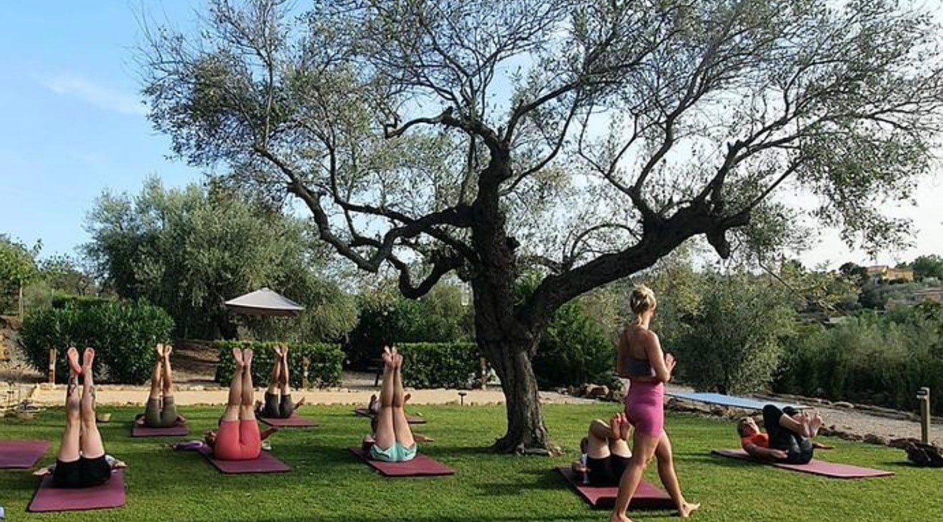 Women moving together outdoors in a serene natural setting
